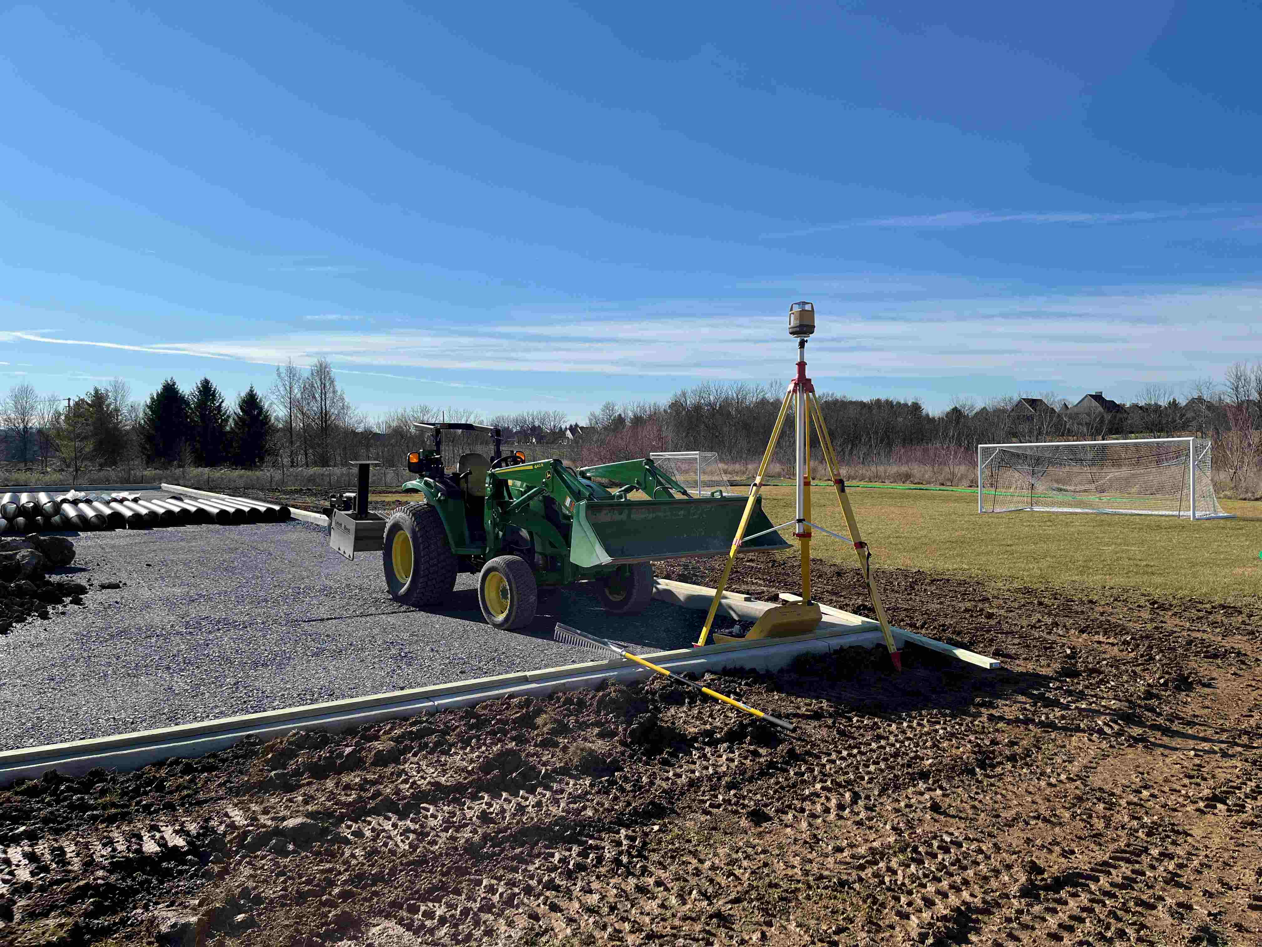 Tractor and survey equipment on an active construction site